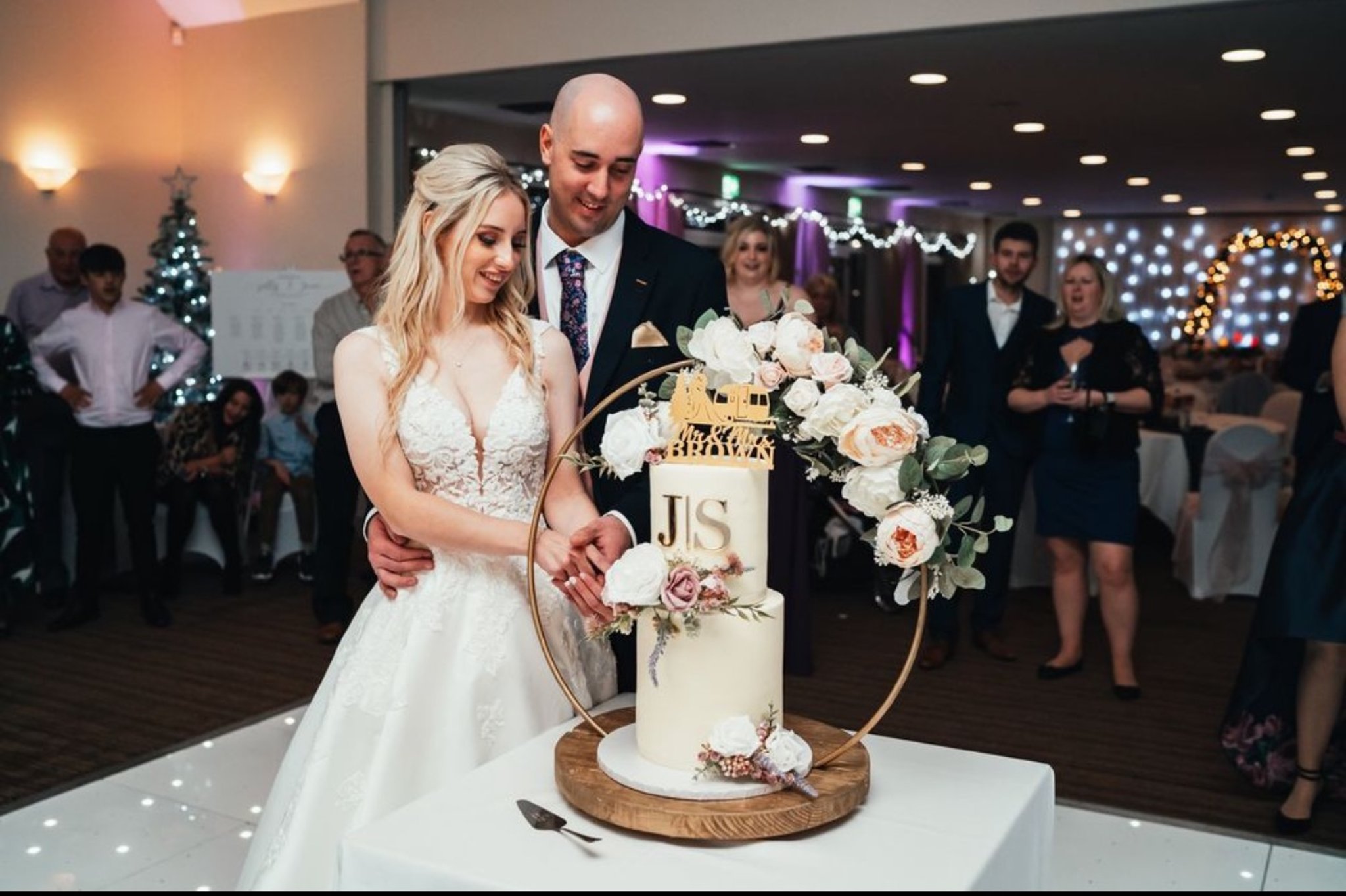 Bride and groom cutting into a wedding cake