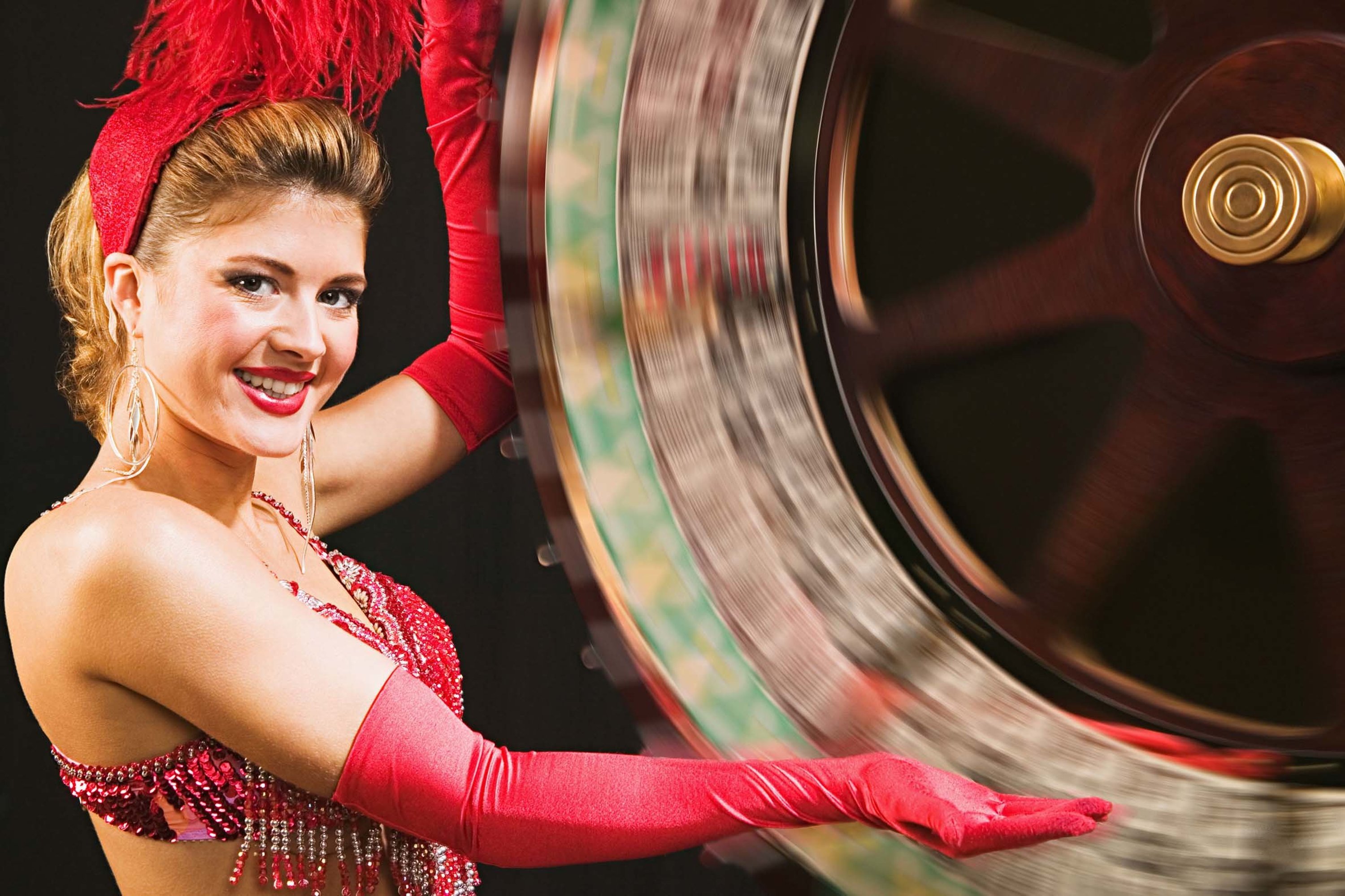 woman dressed as a casino assistant spinning a blackjack wheel