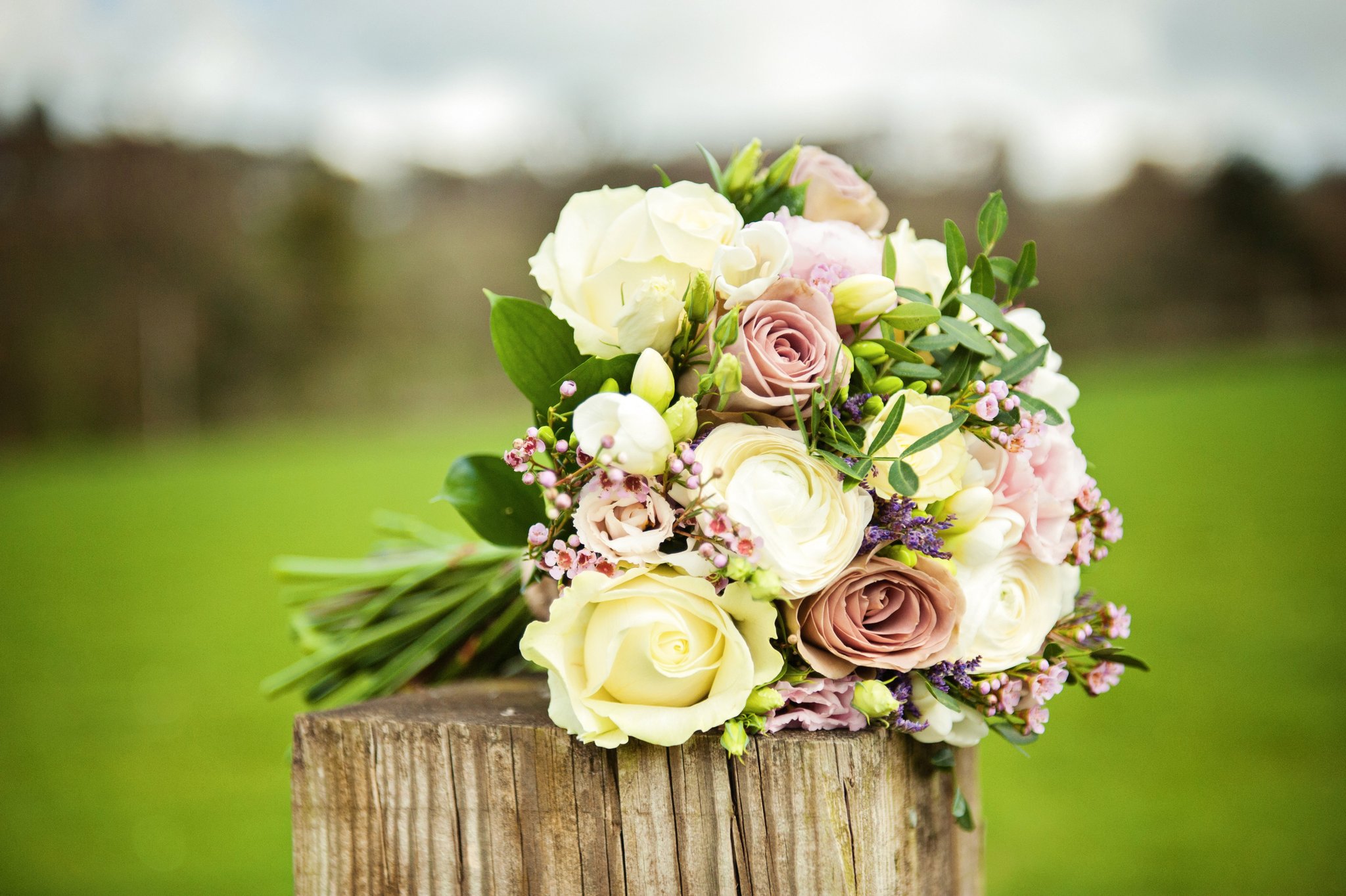 A bridal bouquet of cream and pink roses