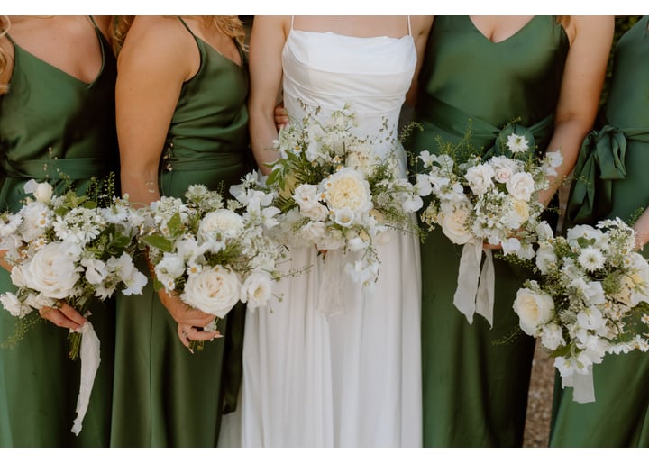Bride with wedding party holding florals