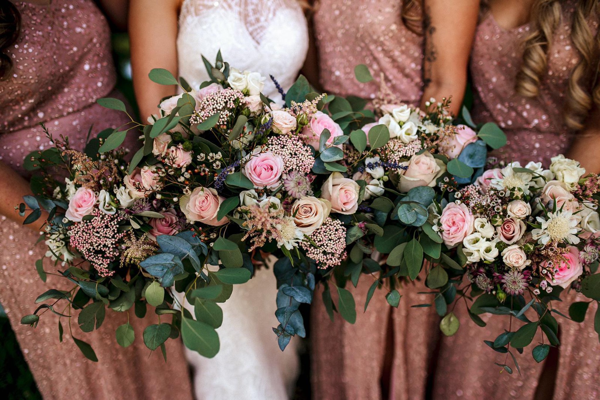 bride and bridesmaids holding their wedding bouquets