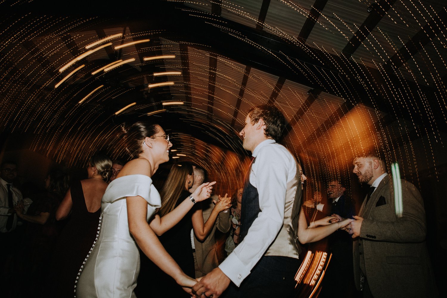 Motion shot of the newly wedded couple dancing at their reception