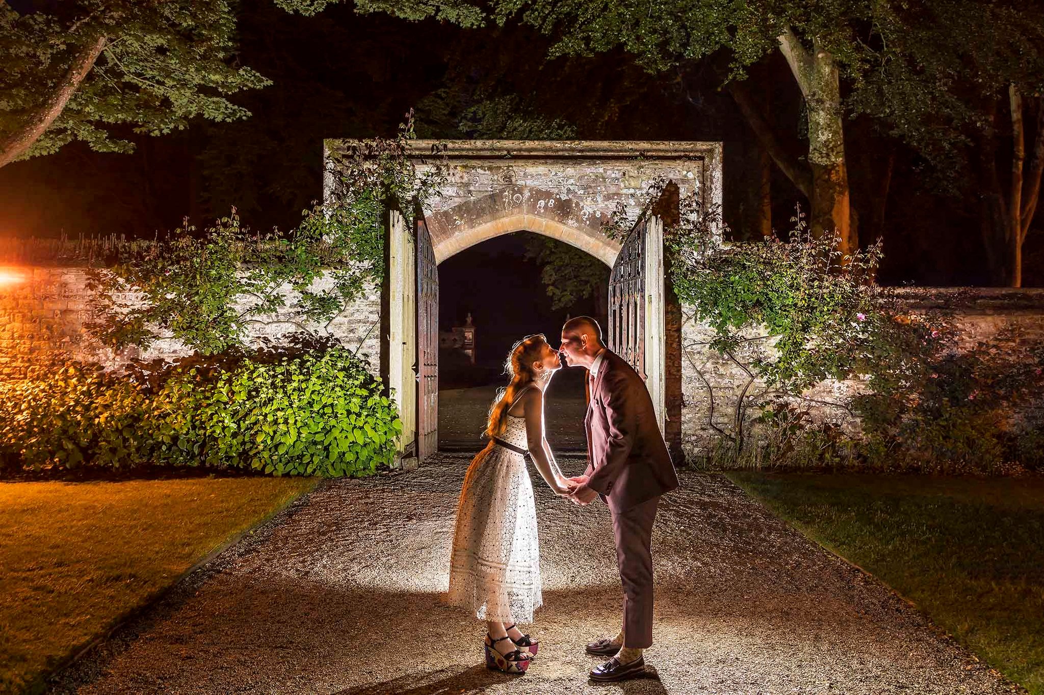 Bride and groom kissing outside a wedding venue