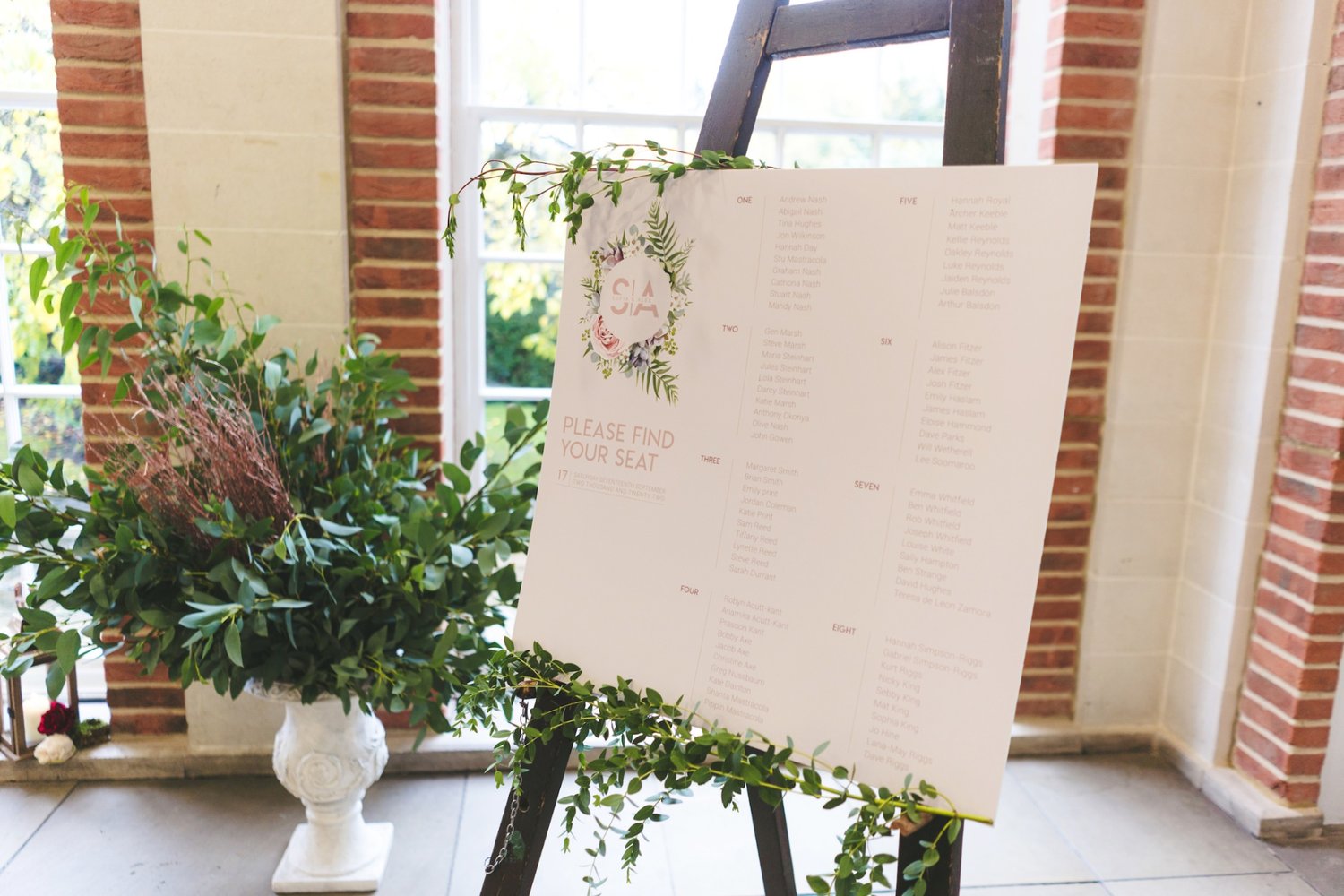 a pink green and white seating chart sign for a wedding