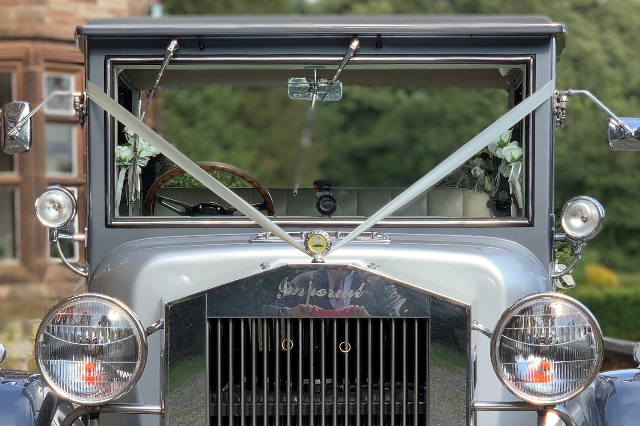 Close up of a vintage wedding car decorated with ribbon