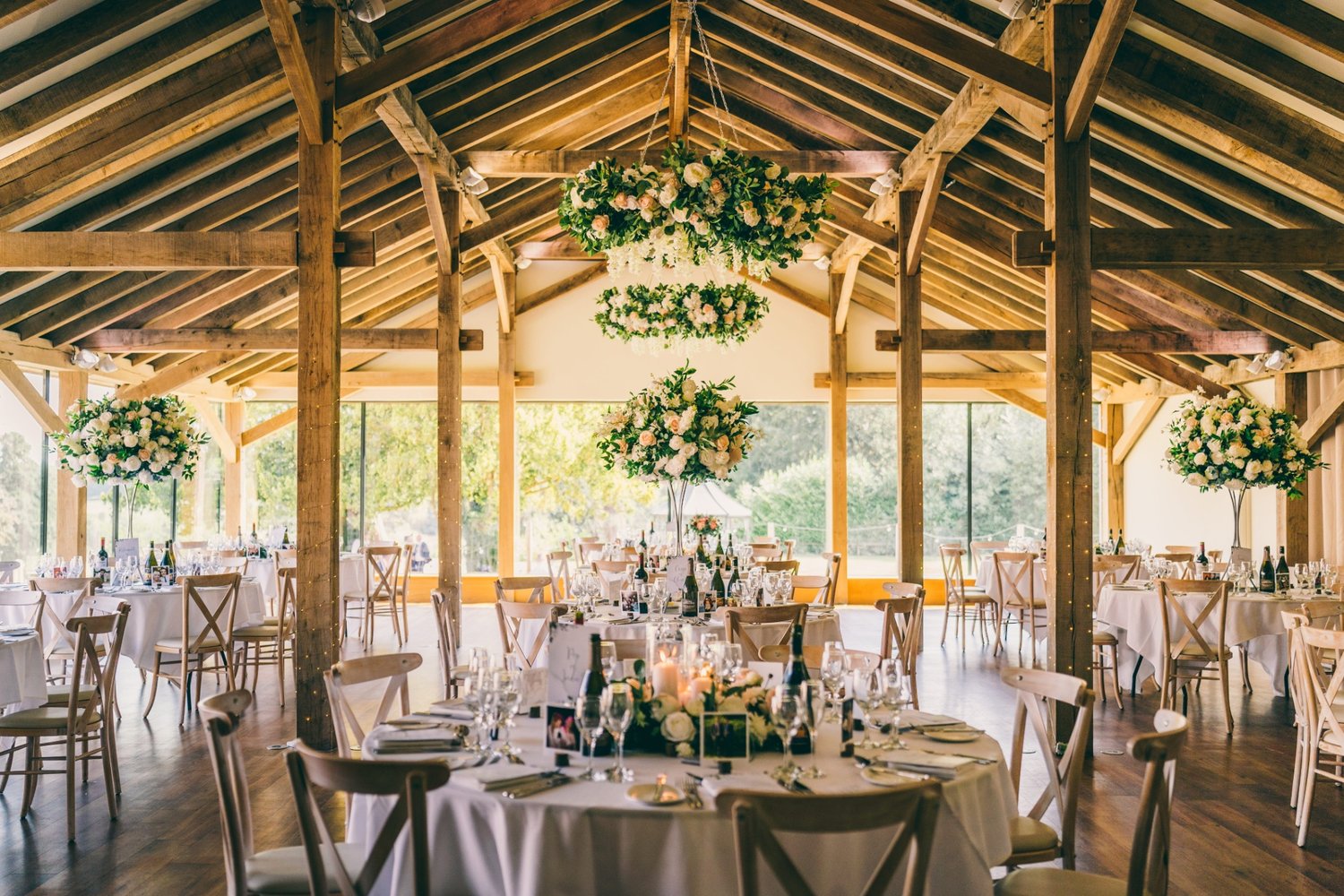 Inside of a wedding venue set up for a wedding breakfast