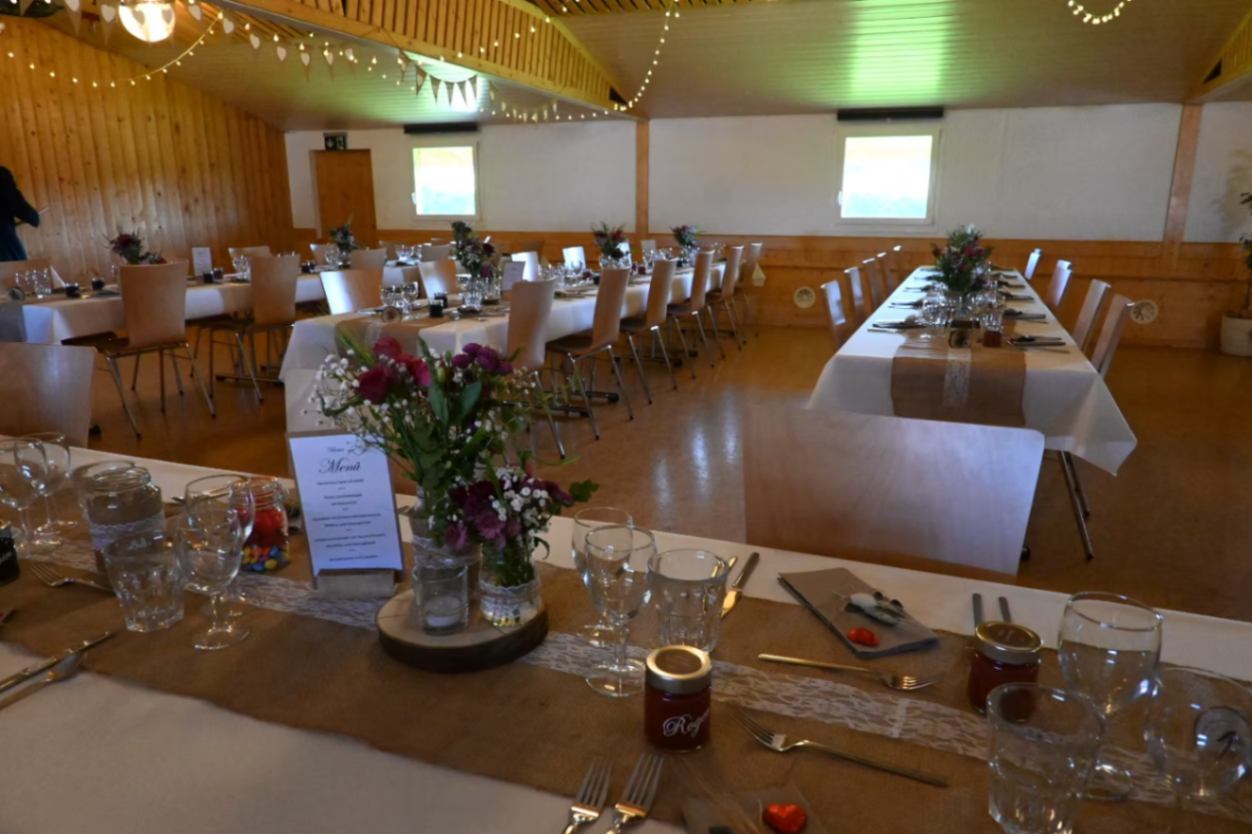 Festlich gedeckte Tafel mit Blumen und Menükarte im Saal