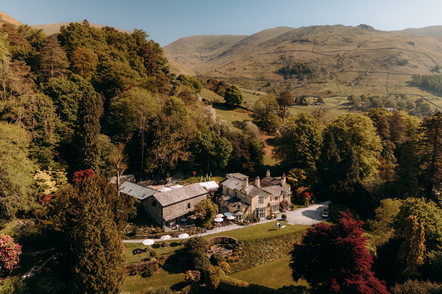 The exterior of the wedding venue with rolling hills and trees turning from green to autumn colours