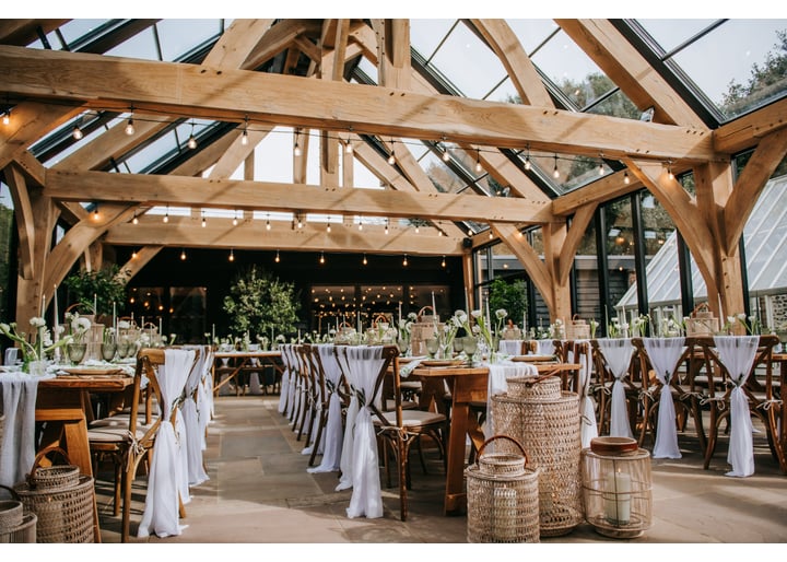 Interior of a wedding barn venue set up for a wedding breakfast