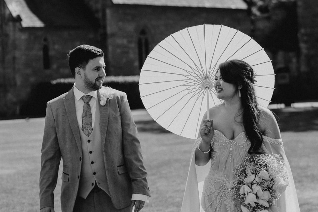Bride and groom walking together outside of their wedding venue