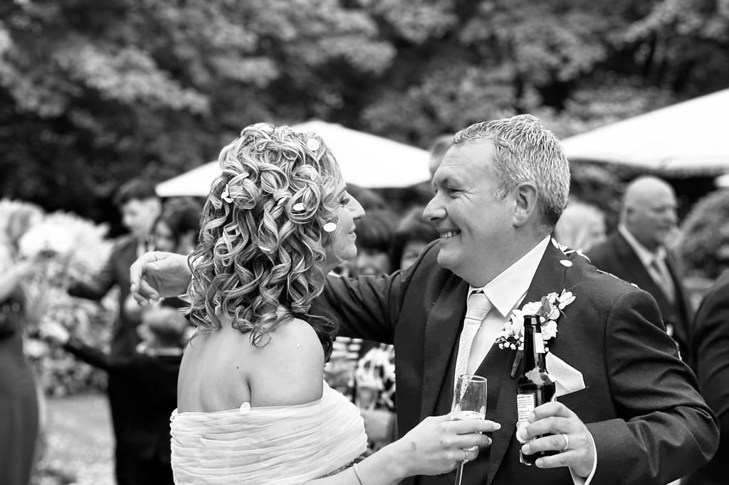 A bride and groom embracing with confetti in their hair